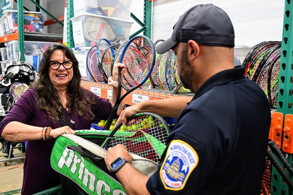 Sharon Daugherty with a DC Metropolitan Police officer at a Baller Brigade equipment pickup